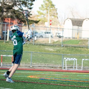 JV lacrosse player prepares to shoot a goal